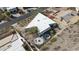 Aerial shot of a modern, triangular home, showcasing unique architecture with landscaping, a fire pit, and spa at 1340 E Las Palmaritas Dr, Phoenix, AZ 85020