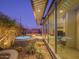 Backyard featuring a modern home with large windows, a hot tub, fire pits, and desert landscaping at 1340 E Las Palmaritas Dr, Phoenix, AZ 85020