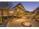 Chic backyard showcasing a modern home with large windows, a fire pit, a hot tub, and desert landscaping at 1340 E Las Palmaritas Dr, Phoenix, AZ 85020