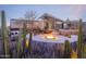 Luxury backyard featuring desert landscaping, a modern home with floor-to-ceiling windows, a hot tub and fire pit at 1340 E Las Palmaritas Dr, Phoenix, AZ 85020