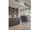 Sitting area features a gray chair next to a bar with gray stone counters and wine on shelves at 1340 E Las Palmaritas Dr, Phoenix, AZ 85020