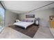 Bright bedroom features a sliding glass door to a deck with views of the desert landscape at 1340 E Las Palmaritas Dr, Phoenix, AZ 85020