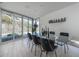 Dining room features a glass table with seating for eight and a desert view through the windows at 1340 E Las Palmaritas Dr, Phoenix, AZ 85020