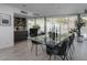 Dining room features a glass table with seating for eight, bar area, and desert view through the windows at 1340 E Las Palmaritas Dr, Phoenix, AZ 85020