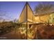 Modern architectural home with a sloped design, complemented by desert landscaping and hillside views at 1340 E Las Palmaritas Dr, Phoenix, AZ 85020