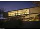 Striking modern home featuring an elevated design and expansive windows, beautifully lit at twilight at 1340 E Las Palmaritas Dr, Phoenix, AZ 85020