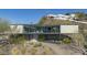 Modern home with balconies and large windows on a hillside with desert landscaping at 1340 E Las Palmaritas Dr, Phoenix, AZ 85020