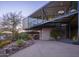 Unique modern home showcasing clean lines, an elevated design, desert landscaping, and exterior staircase at 1340 E Las Palmaritas Dr, Phoenix, AZ 85020