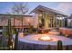 Chic outdoor firepit area with cozy seating, mature cacti, and modern architectural details at 1340 E Las Palmaritas Dr, Phoenix, AZ 85020