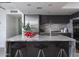 Modern kitchen island with waterfall countertops and seating at 1340 E Las Palmaritas Dr, Phoenix, AZ 85020