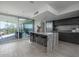 Bright, modern kitchen featuring a large island and access to an outdoor balcony at 1340 E Las Palmaritas Dr, Phoenix, AZ 85020
