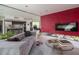 Modern living space featuring a unique red accent wall, fireplace, and sleek furniture at 1340 E Las Palmaritas Dr, Phoenix, AZ 85020