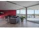 Bright living room featuring hardwood floors, a red accent wall, and sliding glass doors to the balcony at 1340 E Las Palmaritas Dr, Phoenix, AZ 85020