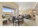 Open-concept dining area with balcony access, table for four, and a view into the cozy living room at 13700 N Fountain Hills Blvd # 365, Fountain Hills, AZ 85268