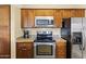 Modern kitchen with stainless steel appliances, granite countertops, and wooden cabinetry at 13700 N Fountain Hills Blvd # 365, Fountain Hills, AZ 85268
