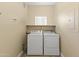 Functional laundry area with modern washer and dryer, ample storage, and neutral color palette at 13700 N Fountain Hills Blvd # 365, Fountain Hills, AZ 85268