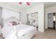 Bedroom featuring a vintage bed frame reflected in mirrored closet doors, plus soft natural light at 14363 W Acapulco Ln, Surprise, AZ 85379