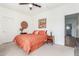 Bright bedroom featuring carpet, ceiling fan, and neutral walls with a colorful accent wall hanging at 14363 W Acapulco Ln, Surprise, AZ 85379