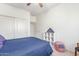 Bedroom with a ceiling fan, carpeting, shelving, and red, white, and blue decor at 14363 W Acapulco Ln, Surprise, AZ 85379