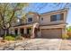 Charming two-story home with a covered porch, well-kept yard, and attached two-car garage at 14363 W Acapulco Ln, Surprise, AZ 85379