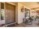 Comfortable front porch featuring cozy chairs, potted plants, and a stylish welcome mat at 14363 W Acapulco Ln, Surprise, AZ 85379