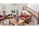 Bright living room featuring comfortable seating, a wooden coffee table, and a staircase at 14363 W Acapulco Ln, Surprise, AZ 85379