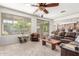 Bright living room with a large window and sliding door, flowing into an open floor plan at 14363 W Acapulco Ln, Surprise, AZ 85379