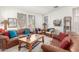 Cozy living room featuring comfortable leather sofas, a wooden coffee table, and natural light at 14363 W Acapulco Ln, Surprise, AZ 85379