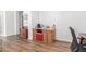 Office area with a desk, chair, wood-style flooring, and a built-in coffee bar at 14363 W Acapulco Ln, Surprise, AZ 85379