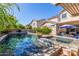 Inviting backyard pool with lush greenery, a pergola, and lounge chairs for relaxation and outdoor enjoyment at 14363 W Acapulco Ln, Surprise, AZ 85379