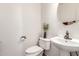 Cozy powder room with pedestal sink, decorative mirror, and neutral tones at 14363 W Acapulco Ln, Surprise, AZ 85379