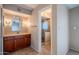 Bathroom featuring a wooden vanity, a framed mirror, and a walk-in shower behind a frameless glass door at 14625 N 25Th Pl, Phoenix, AZ 85032