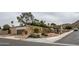 Street view of a single story desert home featuring a well kept yard and an attached garage at 14625 N 25Th Pl, Phoenix, AZ 85032