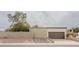 Exterior shot of the single-story home displaying the garage and desert landscaping at 14625 N 25Th Pl, Phoenix, AZ 85032