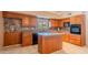 Updated kitchen featuring wood cabinets, granite countertops, an island and stainless steel appliances at 14625 N 25Th Pl, Phoenix, AZ 85032