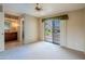 Main bedroom with neutral carpet, ceiling fan, walk-in closet, and sliding door to the backyard at 14625 N 25Th Pl, Phoenix, AZ 85032