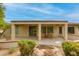Covered patio with wooden table and backyard view showcasing landscaping at 15046 W Cooperstown Way, Surprise, AZ 85374