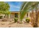 View of covered patio from the backyard with mature landscaping and trees at 15046 W Cooperstown Way, Surprise, AZ 85374