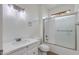 Clean bathroom with vanity, toilet, and bathtub with sliding glass doors at 15046 W Cooperstown Way, Surprise, AZ 85374