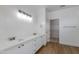 Bathroom featuring double sinks, white cabinets, and a walk-in closet at 15046 W Cooperstown Way, Surprise, AZ 85374