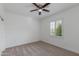 Bedroom with carpet, ceiling fan, and a window with plantation shutters at 15046 W Cooperstown Way, Surprise, AZ 85374