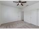 Bedroom features carpet, ceiling fan, and closet with sliding doors at 15046 W Cooperstown Way, Surprise, AZ 85374