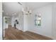 Bright dining room showcasing an open layout, wood floors, and view to the kitchen at 15046 W Cooperstown Way, Surprise, AZ 85374