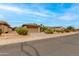 Charming single-story home featuring desert landscaping, a two-car garage, and a tile roof at 15046 W Cooperstown Way, Surprise, AZ 85374