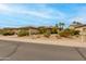 Charming single-story home featuring desert landscaping, a two-car garage, and a tile roof at 15046 W Cooperstown Way, Surprise, AZ 85374