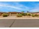 Charming single-story home featuring desert landscaping, a two-car garage, and a tile roof at 15046 W Cooperstown Way, Surprise, AZ 85374