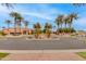 Attractive exterior view of the building with palm trees, landscaping, and roundabout driveway at 15046 W Cooperstown Way, Surprise, AZ 85374