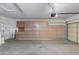 Bright garage featuring a motorized door and lots of built-in storage cabinets at 15046 W Cooperstown Way, Surprise, AZ 85374