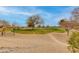 Scenic view of the golf course featuring dry desert landscaping with mature trees at 15046 W Cooperstown Way, Surprise, AZ 85374