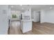 Open kitchen with white cabinets and stainless steel appliances at 15046 W Cooperstown Way, Surprise, AZ 85374